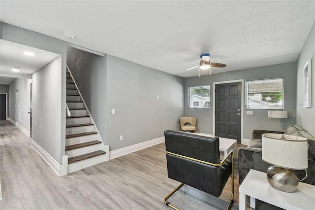 3411 N 12th St, Tampa, FL 33605 - living area featuring baseboards, stairs, wood finished floors, and a ceiling fan