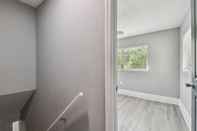 3411 N 12th St, Tampa, FL 33605 - stairs with baseboards, a textured ceiling, and wood finished floors