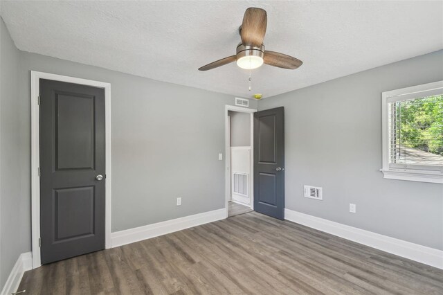 3411 N 12th St, Tampa, FL 33605 - unfurnished bedroom featuring baseboards, visible vents, wood finished floors, and a textured ceiling