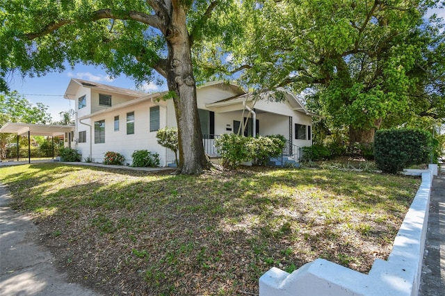 3411 N 12th St, Tampa, FL 33605 - view of side of property with a carport and a yard