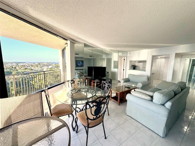 690 Island Way Unit 707, Clearwater Beach, FL 33767 - living area with a textured ceiling and light tile patterned flooring