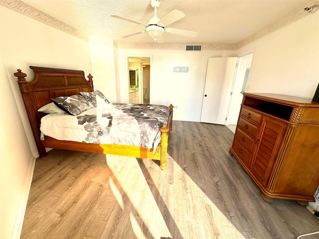690 Island Way Unit 707, Clearwater Beach, FL 33767 - bedroom featuring wood finished floors, ensuite bath, and ceiling fan