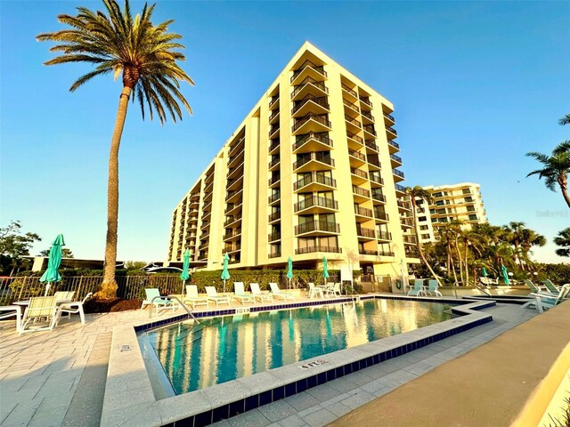 690 Island Way Unit 707, Clearwater Beach, FL 33767 - community pool featuring a patio area and fence