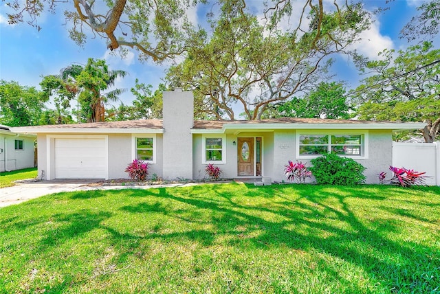ranch-style house featuring stucco siding, driveway, an attached garage, a front yard, and fence