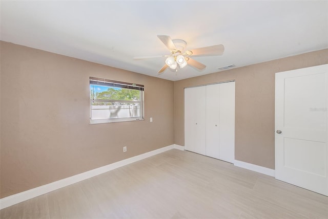 unfurnished bedroom featuring visible vents, baseboards, a closet, and ceiling fan