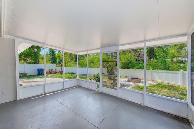 unfurnished sunroom with a fire pit