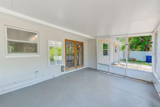 unfurnished sunroom with french doors