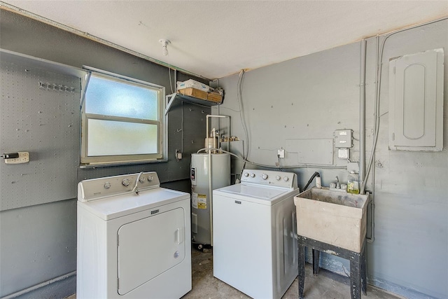clothes washing area featuring electric panel, washer and dryer, water heater, and a sink