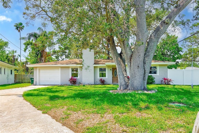 ranch-style home featuring stucco siding, driveway, a front lawn, a garage, and fence