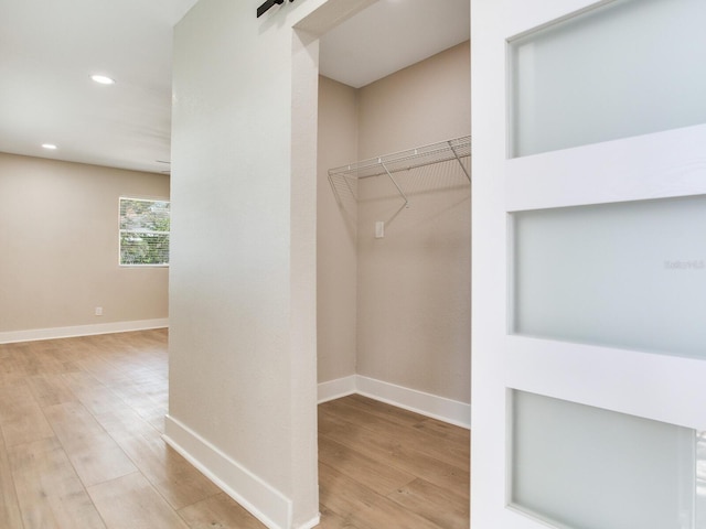 spacious closet with wood finished floors