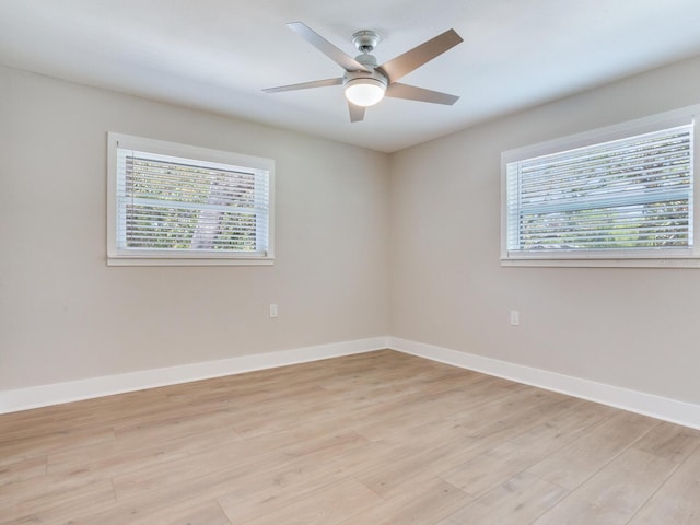 unfurnished room featuring a ceiling fan, light wood-style flooring, and baseboards