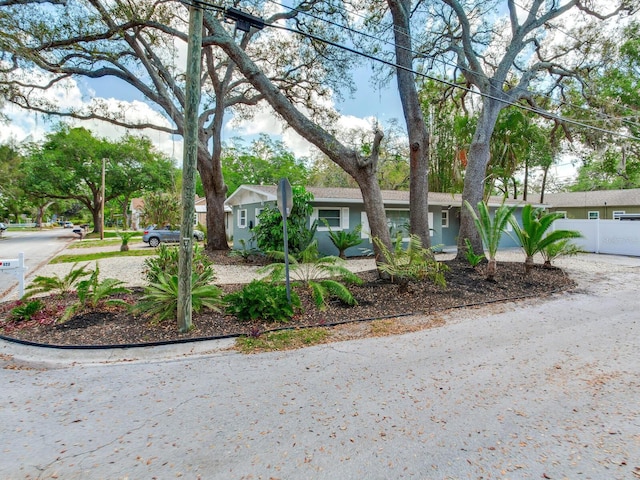 ranch-style house with stucco siding and fence