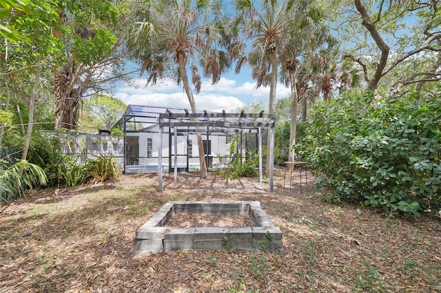 view of yard with a pergola and an outdoor fire pit