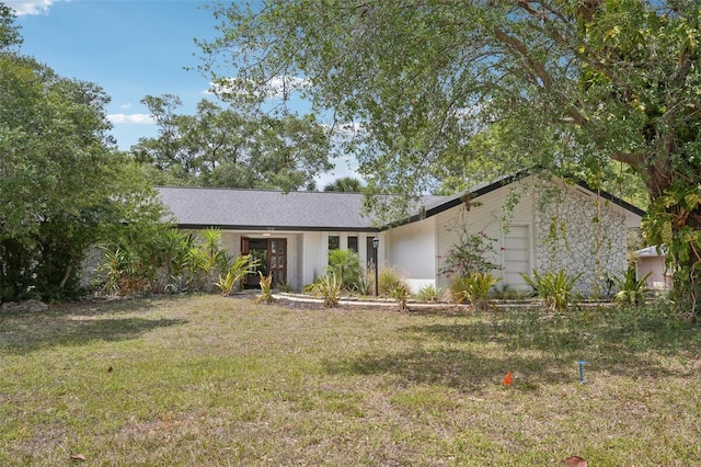 mid-century modern home featuring a garage and a front yard