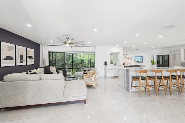living area with visible vents, recessed lighting, light tile patterned flooring, and a ceiling fan