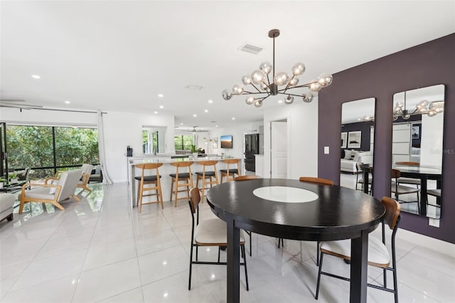 dining room featuring recessed lighting, arched walkways, an inviting chandelier, and light tile patterned flooring