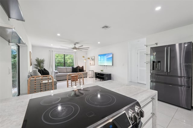 kitchen with stainless steel fridge with ice dispenser, electric range oven, visible vents, and recessed lighting
