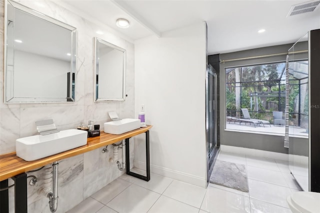 bathroom with tile patterned floors, visible vents, a sink, and decorative backsplash
