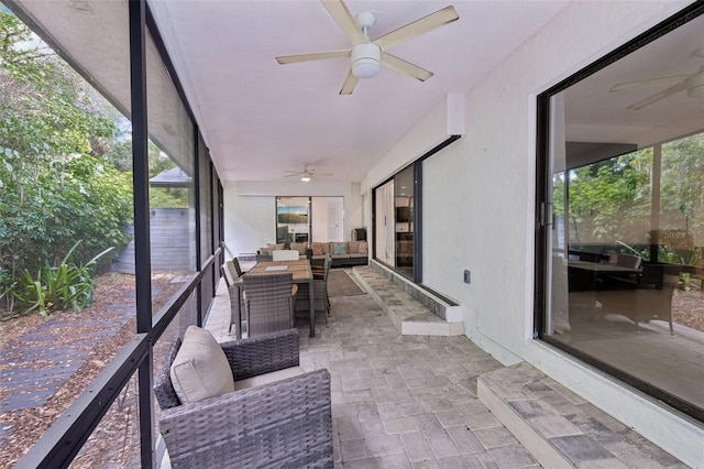 sunroom / solarium featuring plenty of natural light, outdoor lounge area, and ceiling fan