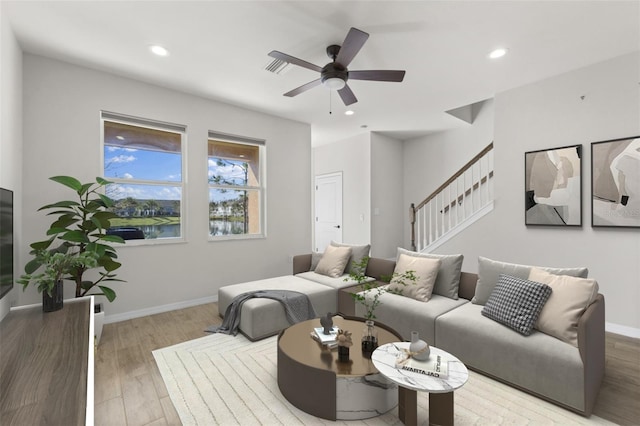 living area with baseboards, stairs, wood finished floors, and recessed lighting