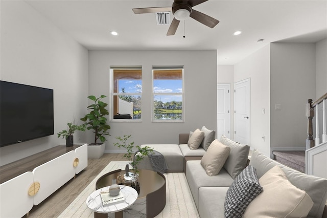 living room featuring stairs, wood finished floors, recessed lighting, and a ceiling fan