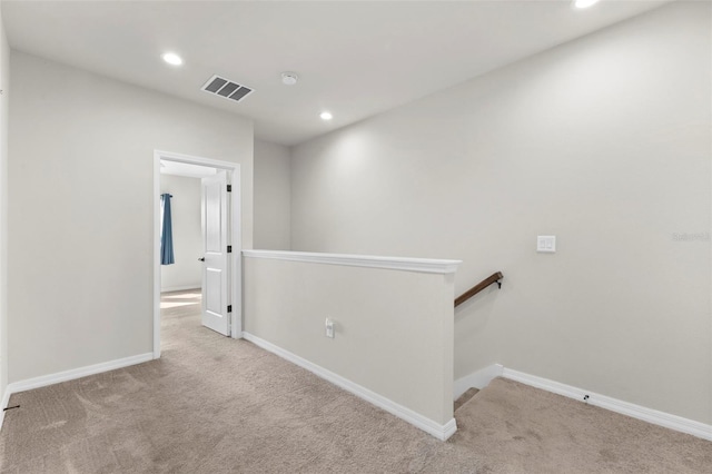 corridor with carpet flooring, recessed lighting, an upstairs landing, and visible vents