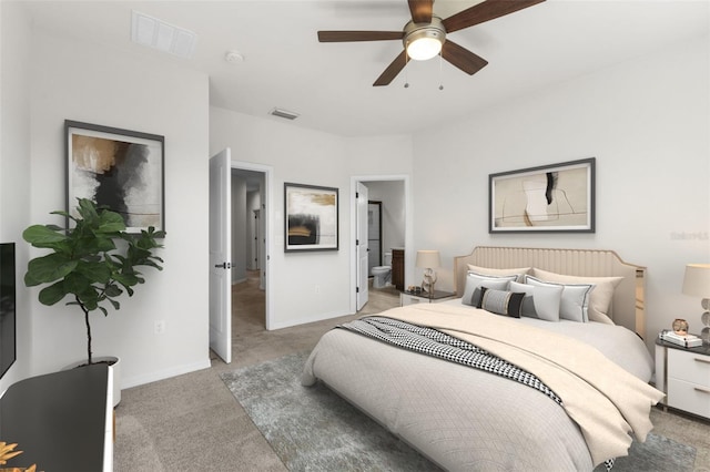 bedroom featuring baseboards, visible vents, carpet flooring, and ensuite bath