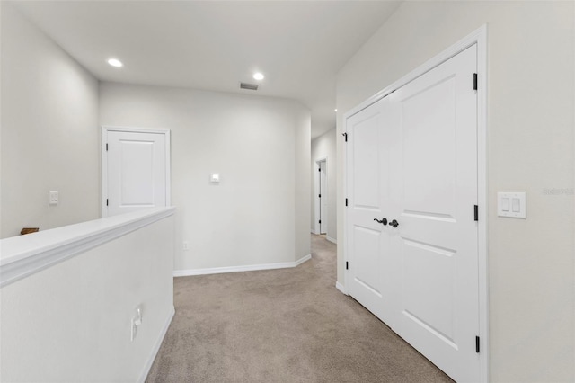 hall with recessed lighting, baseboards, light colored carpet, and visible vents