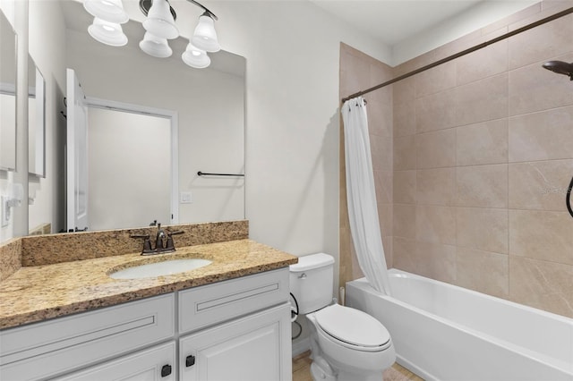 full bath featuring shower / bath combo with shower curtain, vanity, and toilet