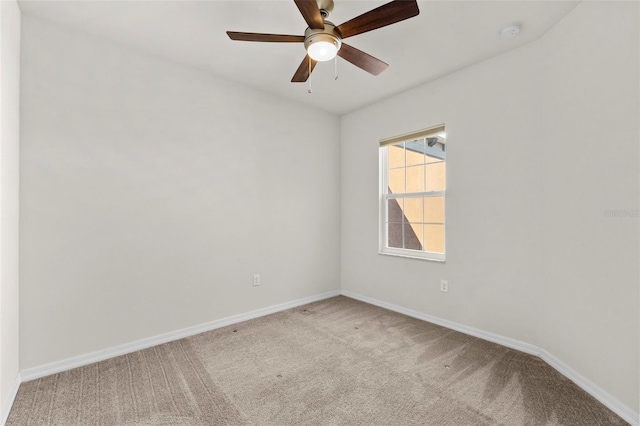 carpeted empty room with baseboards and ceiling fan
