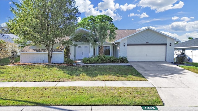 view of front of home featuring a front lawn, driveway, stucco siding, and an attached garage