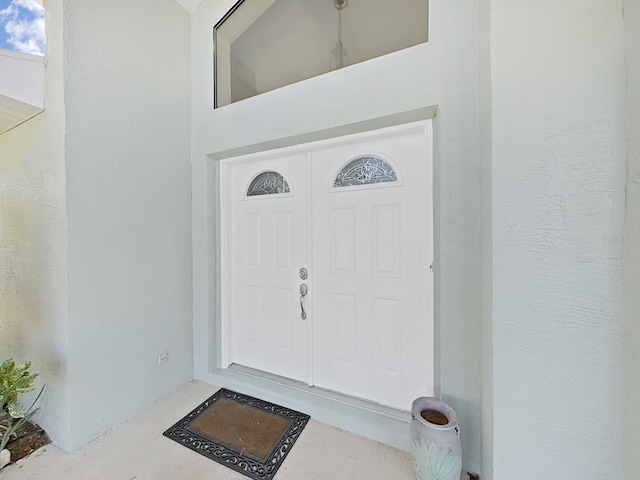 entrance to property featuring stucco siding