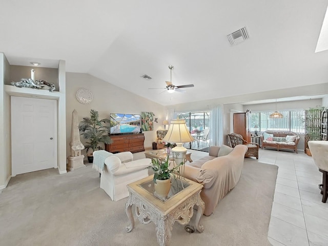 living area featuring light tile patterned flooring, visible vents, vaulted ceiling, and a ceiling fan