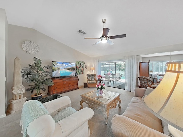 living area with carpet flooring, a ceiling fan, lofted ceiling, and visible vents