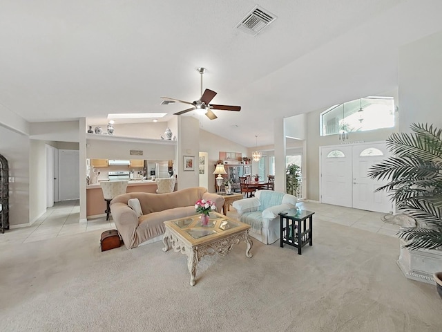living room with light tile patterned flooring, visible vents, ceiling fan with notable chandelier, and light carpet