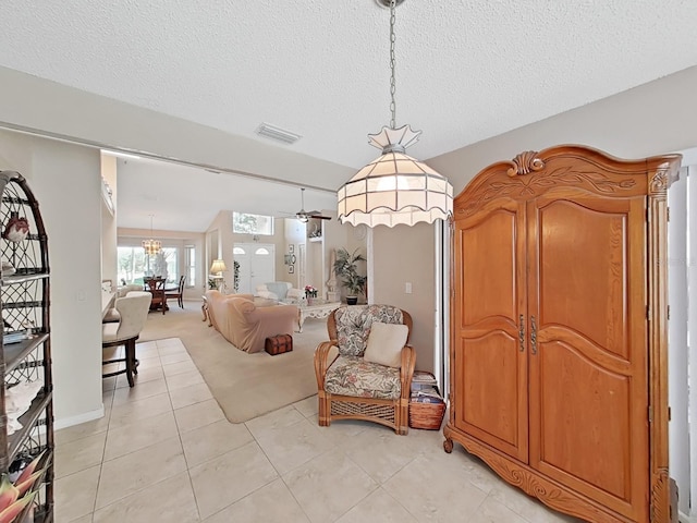 sitting room featuring a ceiling fan, light carpet, a textured ceiling, and visible vents