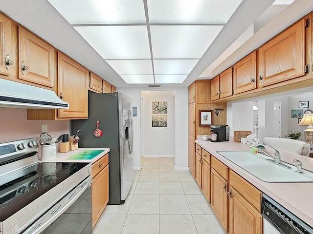 kitchen featuring a sink, white dishwasher, under cabinet range hood, light tile patterned floors, and electric stove