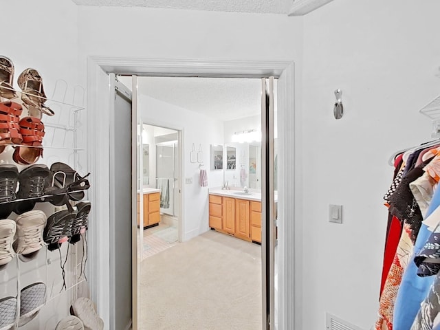 bathroom featuring a textured ceiling, visible vents, and vanity