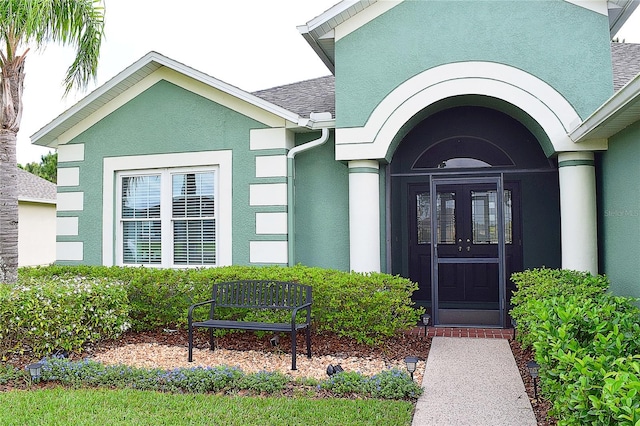 entrance to property with stucco siding and french doors