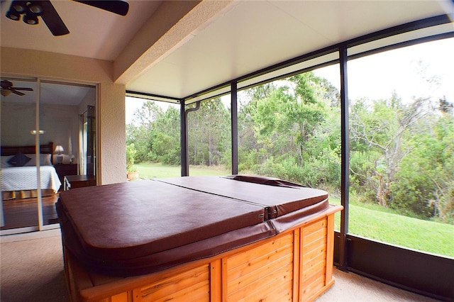 sunroom / solarium with a jacuzzi