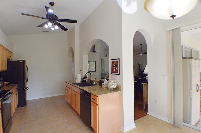 kitchen featuring black appliances, arched walkways, ceiling fan, and a sink