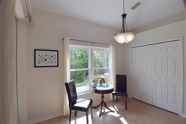 living area with baseboards, visible vents, and light tile patterned floors