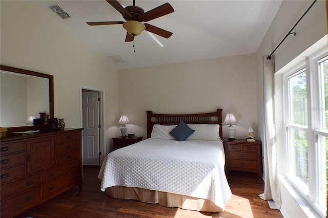 bedroom featuring vaulted ceiling, visible vents, wood finished floors, and ceiling fan