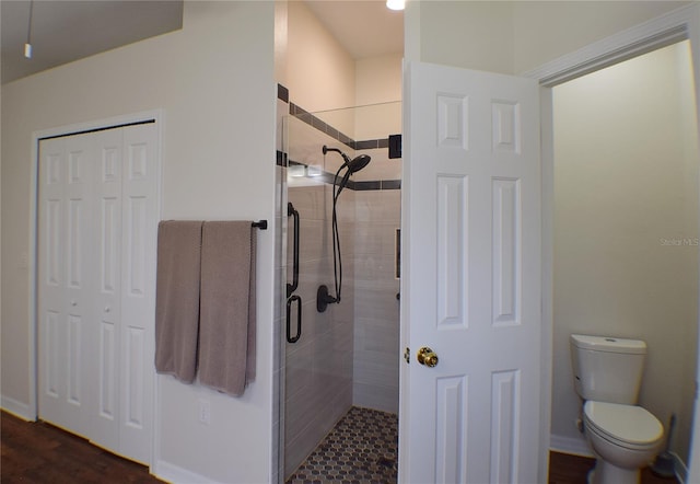 full bathroom featuring toilet and a shower stall