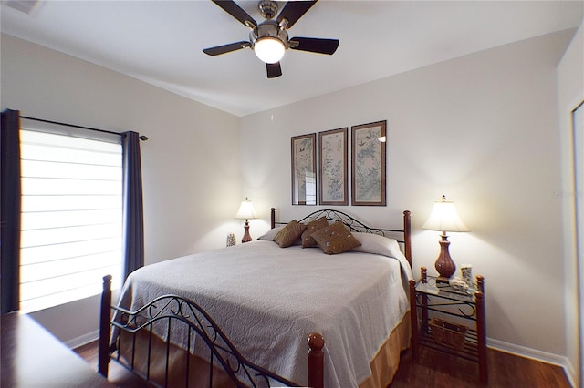 bedroom with a ceiling fan, baseboards, and wood finished floors