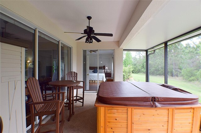 sunroom featuring a hot tub and a ceiling fan