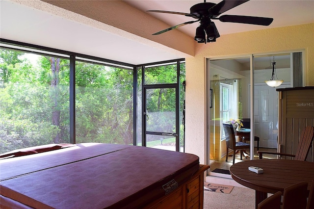 bedroom featuring a ceiling fan and a textured wall