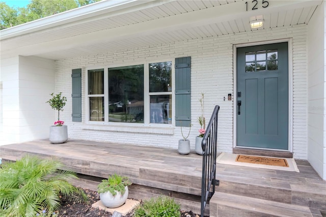 125 Siobhan Ave, Tampa, FL 33613 - view of exterior entry featuring brick siding and a porch