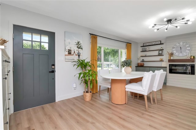 125 Siobhan Ave, Tampa, FL 33613 - dining space featuring light wood-style flooring, baseboards, and a chandelier