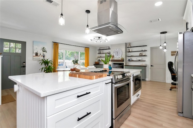 125 Siobhan Ave, Tampa, FL 33613 - kitchen featuring visible vents, white cabinets, appliances with stainless steel finishes, and extractor fan